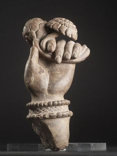 a sculpture of a hand holding something in it's palm