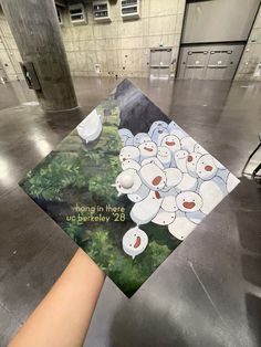 a hand holding up a card with an image of bears on it in a building