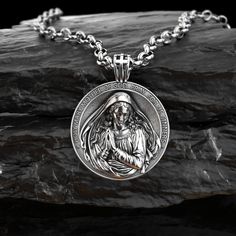 This silver necklace is handmade by Burning Ship Metalworks. It is made from recycled silver. A Renaissance-inspired version of Virgin Mary pendant, cast in .925 sterling silver, and handmade with a lot of love. Cast with a nice bright polished finish that will keep it shiny for a long time to come. The Virgin Mary is making an appearance in churches across the world. An increase in the popularity of this religious icon has set new records for sales, creating a great demand for items such as fig Spiritual Silver Medallion Pendant Necklace, Stainless Steel Medallion Coin Pendant Jewelry, Stainless Steel Large Pendant Necklaces, Symbolic Sterling Silver Pendant Medallion Necklace, Silver Polished Medallion Necklace, Stainless Steel Jewelry With Large Pendant As Gift, Stainless Steel Large Pendant Jewelry Gift, Symbolic Medallion Jewelry For Memorial, Silver Spiritual Medallion Necklace Gift