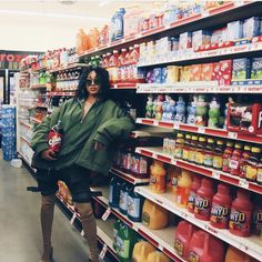 a woman is standing in the aisle of a store