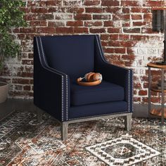 a blue chair sitting in front of a brick wall