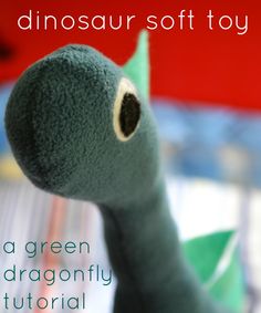 a close up of a stuffed animal with the words dinosaur soft toy in front of it