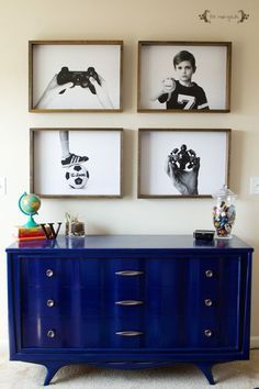 three framed pictures hang above a blue dresser