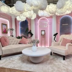 the living room is decorated in pink and white with fluffy clouds hanging from the ceiling