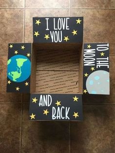 a cardboard box with the words i love you and back written on it, sitting on a tile floor