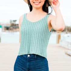 a woman wearing a straw hat posing for the camera