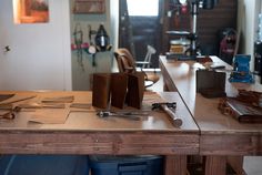 a wooden table topped with lots of tools