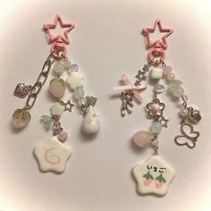 two key chains with charms attached to them