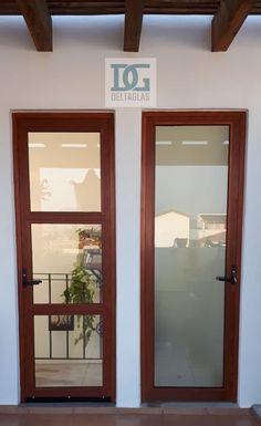 two wooden doors with glass on the outside