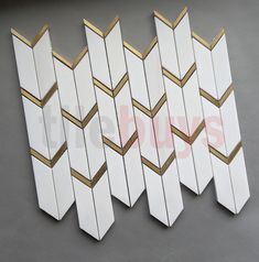 several white and gold geometric mirrors on the wall