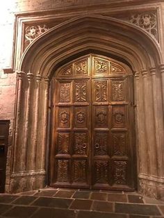 an ornately carved wooden door in a stone building