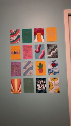 the wall is decorated with many colorful cards