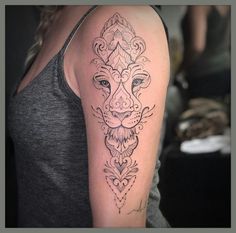 a woman with a lion tattoo on her arm