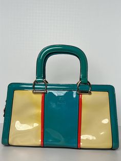 KH Paris handbag never used, satchel handbag with a stylish eye catching design featuring a vibrant mix of turquoise, yellow orange pink, this bag is perfect for making statement. It has handle drop for easy carrying.The bag include a secure zip closure and comes with a detachable strap, allowing you to wear it on the shoulder or cross body for added versatility. Multicolor Square Shoulder Bag With Detachable Handle, Elegant Multicolor Shoulder Bag With Gold-tone Hardware, Rectangular Yellow Shoulder Bag With Zipper Closure, Multicolor Rectangular Shoulder Bag With Gold-tone Hardware, Yellow Shoulder Bag With Gold-tone Hardware And Top Handle, Yellow Orange Pink, Rose Orange, Satchel Handbags, Yellow Orange