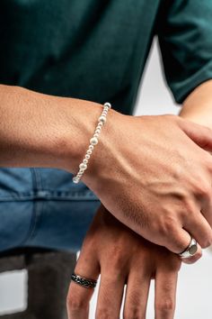 Pictured here is our most popular pearl bracelet and some of our silver rings. This is our minimal pearl bracelet, vintage signet ring in silver and our minimal ring in polished silver. These have all become staples in both men's jewelry and in men's fashion. Follow and check us out for more! Luxury White Pearl Bracelet Timeless Style, Luxury White Pearl Bracelet, Pearl White Baroque Pearl Bracelet, Luxury Elegant Baroque Pearl Bracelet, Luxury White Baroque Pearl Bracelet