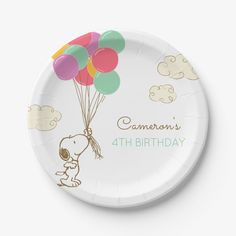 a paper plate with a cartoon character holding balloons in the shape of a baby shower