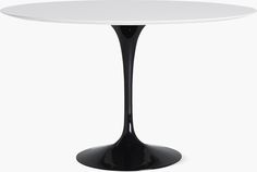 an oval white table with black base