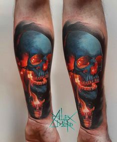 a man's leg with a skull and flames tattoo on his legs, while he is