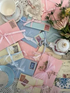 a table topped with lots of different types of cards and papers on top of each other