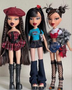 three dolls are standing next to each other