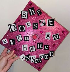 a pink graduation cap with words that spell out she doesn't even go there anymore