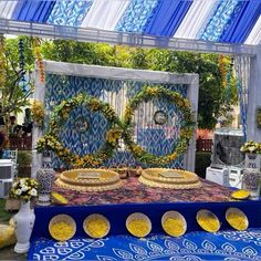 an elaborately decorated bed in the middle of a room with blue and yellow decor