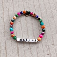 Let your teacher know just how inspiring they are! Show your gratitude to a teacher who made a difference in your life with this stunning bracelet. Featuring a dazzling array of multicolor agate stones, this pretty piece of jewelry is the perfect accessory for a special educator in your life. Rock this as a reminder of your impact or gift to your favorite teacher to show how much you appreciate them. A portion of the proceeds from this bracelet will be donated to DonorsChoose to help classrooms Adjustable Inspirational Multicolor Stretch Bracelet, Inspirational Multicolor Adjustable Stretch Bracelet, Inspirational Adjustable Multicolor Stretch Bracelet, Inspirational Personalized Multicolor Jewelry, Adjustable Multicolor Inspirational Stretch Bracelet, Multicolor Inspirational Jewelry For Friendship, Inspirational Adjustable Multicolor Beaded Bracelets, Everyday Inspirational Multicolor Beaded Bracelets, Everyday Inspirational Multicolor Jewelry