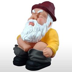 a small gnome figurine sitting on top of a white surface with his eyes closed