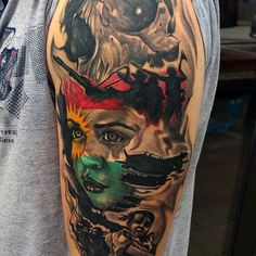 a man with a tattoo on his arm that has a woman's face painted on it