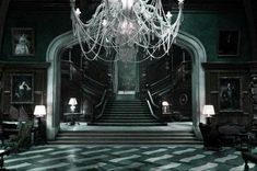 a chandelier hanging from the ceiling in a large room