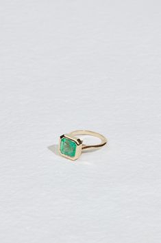 METAL14kt Yellow GoldOpen Bottom Cathedral Bezel Setting1.8mm Soft Knife Edge Band STONE3.15ct Asscher Cut Colombian Emerald Approx. 10.43 x 9.43 x 6.35mm This one-of-a-kind Colombian Emerald beauty is a modern statement. It's soft knife edge band compliments the clean lines within the unique stone. Stack with other JP statements such as the JP KNIFE EDGE BAND and the JP BAGUETTE STRAIGHT BAND. Modern Emerald Ring With Polished Finish For Promise, Modern Emerald Promise Ring With Polished Finish, Modern Polished Emerald Jewelry, Modern Octagon Emerald Ring For Formal Occasions, Modern Asscher Cut Emerald Promise Ring, Modern Jewelry With Asscher Cut And Polished Finish, Modern Octagon Jewelry With Bezel Setting, Modern Emerald-cut Jewelry With Polished Finish, Modern Octagon Emerald Ring