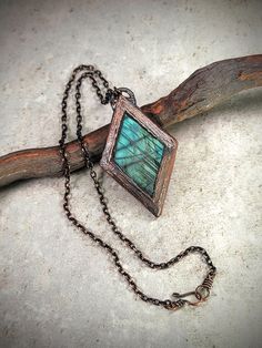 Discover the magic of shifting hues with our Green and Blue Labradorite Diamond-Shaped Copper Electroformed Necklace. This mesmerizing piece captures the enchanting play of light, with a labradorite gemstone that dramatically changes colors from vibrant green to deep blue as you move. Handcrafted in copper, this necklace is a stunning symbol of transformation and protection, reflecting the beauty of the ever-changing world around you. Perfect for adding an element of surprise and elegance to any outfit, this one-of-a-kind piece will captivate and inspire with every glance. Complimentary gift wrapping included Element Of Surprise, Blue Labradorite, Diamond Shaped, Vibrant Green, Green And Blue, Deep Blue, Diamond Shapes, Labradorite, The Magic