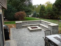 a fire pit sitting on top of a brick patio