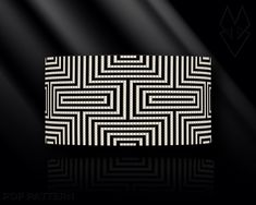 an abstract black and white pattern on a dark background