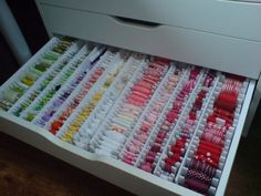 the drawers are filled with many different colored items