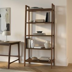 a book shelf with books on it next to a table