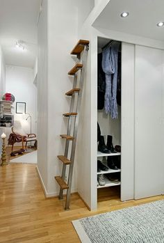 an open closet with a ladder to the top and shoes on the bottom shelf in front of it