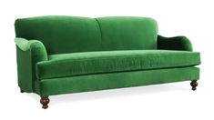 a green velvet couch with wooden legs and arm rests on an isolated white background,