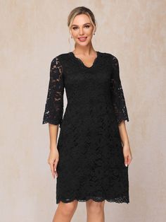 a woman wearing a black lace dress with sleeves and an open v - neckline