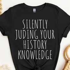 This history shirt makes a totally unique history gift for history teachers and professors, especially during Teacher Appreciation Week and more! Grab this tee today while it's on sale! Delivery Times: ◦ Production: 1 business day on average (maximum: 5) ◦ Shipping: 2 business days on average (maximum: 5) Unisex Fit: ◦ Extra soft, preshrunk unisex t-shirt ◦ Women: Semi-fitted, laidback, rollable, & tuckable ◦ Men: Fitted on upper body & loose around the belly ☞ Size up for a looser fit Soft Materials: ◦ Super soft, preshrunk tee with eco-friendly materials ◦ Black, White, & Navy: 100% soft ring spun cotton ◦ Heather Navy: 65% polyester & 35% cotton ◦ Sport Grey: 90% cotton & 10% polyester Football Wife Shirt, Coaches Wife Shirt, History Teacher Shirt, History Teacher Gifts, Funny History, Whiskey Shirt, Gifts For History Buffs, Funny Teacher Gifts, Coach Shirts