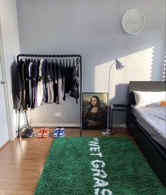 a bedroom with a green rug that says football on the floor next to a bed