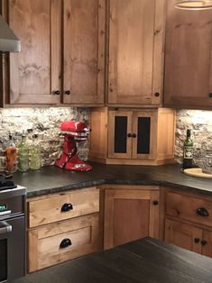 a kitchen with wooden cabinets and an old fashioned blender on the counter top,