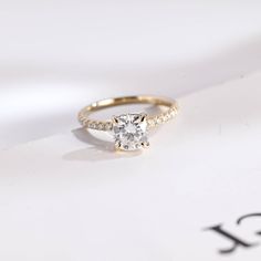 a diamond ring sitting on top of a piece of paper