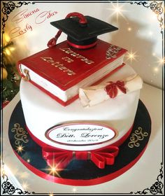 a graduation cake with books and diploma on top