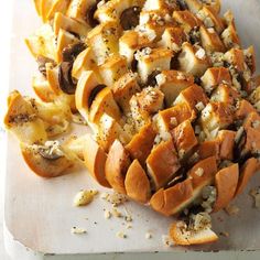 a pile of food sitting on top of a white cutting board