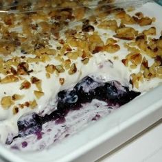 a close up of a plate of food with blueberries and nuts on it's crust