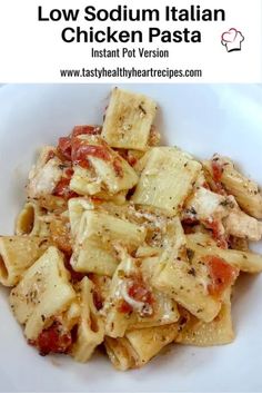 a white bowl filled with pasta covered in sauce and chicken parmesan on top