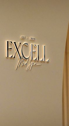 an exceil logo on the side of a white refrigerator with frosting and gold lettering