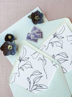 two envelopes with stamps and flowers on them