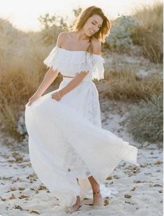 a woman in a white dress on the beach